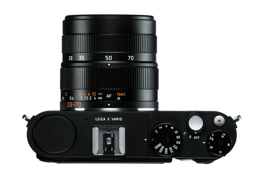   Similar beasts. Note the disparate lens focal distance engravings: With a fixed-lens camera such as the X-Vario it is common to show the 35mm-equivalent focal length (28-70mm) while on an interchangeable lens it is less confusing to use the actual focal length (18-56) and you have to do the x1.5 calculation to make the 28-85mm comparison. Curiously, the zoom on the two lenses has been reversed, with wide angle being to the left on the X-V and to the right on the Vario-Elmar-TL. The latter also loses the focus scale.  